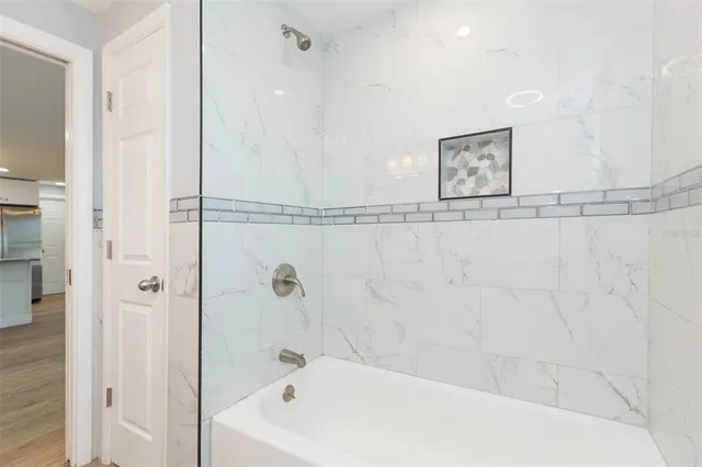 a bathroom with a bathtub and shower