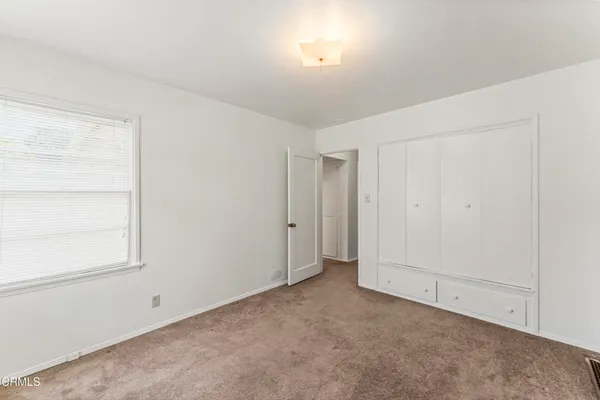 an empty room with a empty space and windows