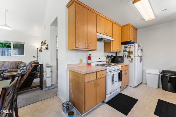 a kitchen with a stove a sink and a refrigerator