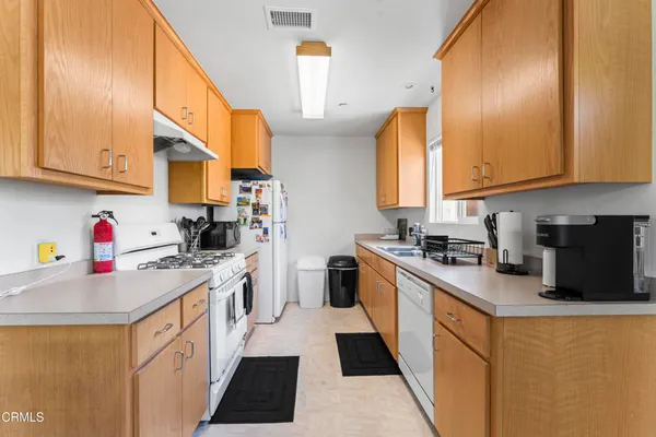 a kitchen with a sink a stove and cabinets