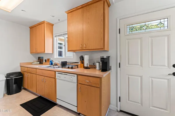 a kitchen with stainless steel appliances granite countertop a sink and a refrigerator