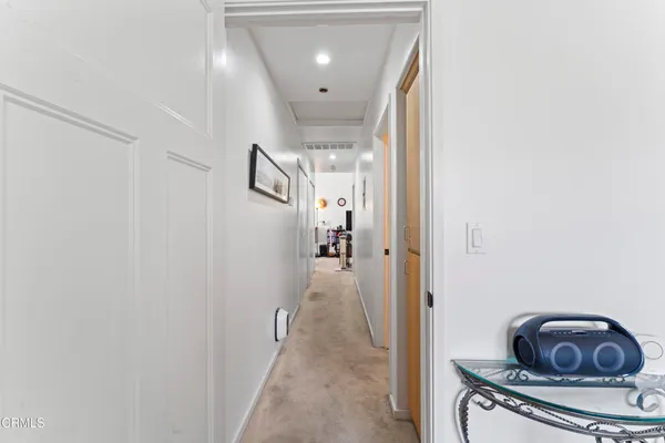 a view of a hallway and a livingroom with wooden floor