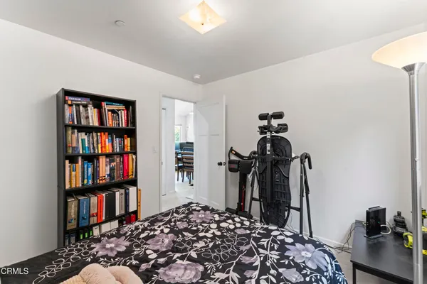 a bedroom with furniture and a book shelf