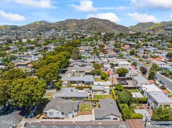 an aerial view of residential houses with city view