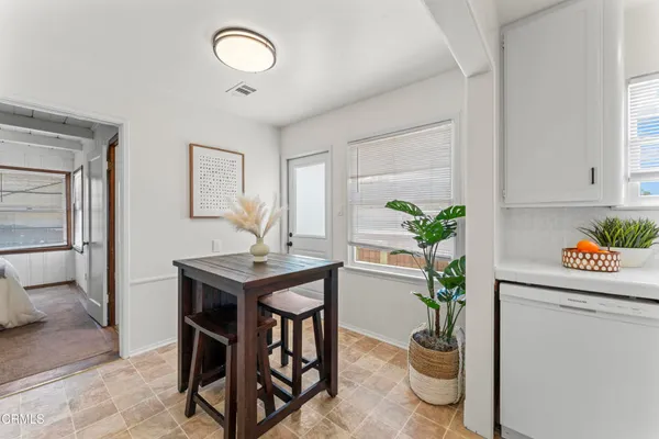 a view of a dining room with furniture window and flowerpot