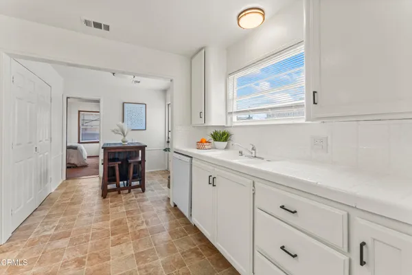 a spacious bathroom with a double vanity sink and a window