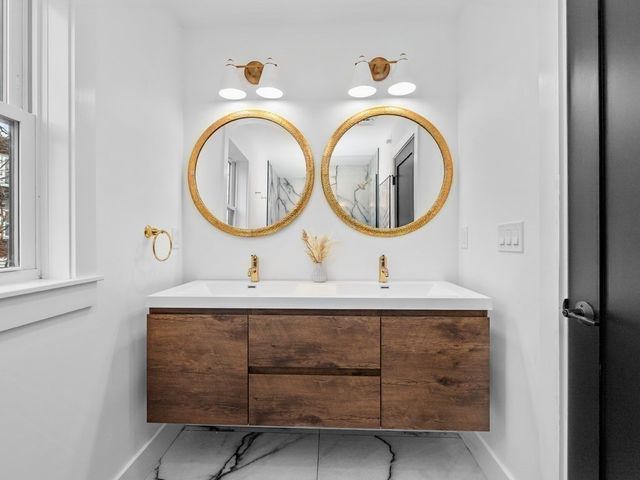 a bathroom with a sink and a mirror