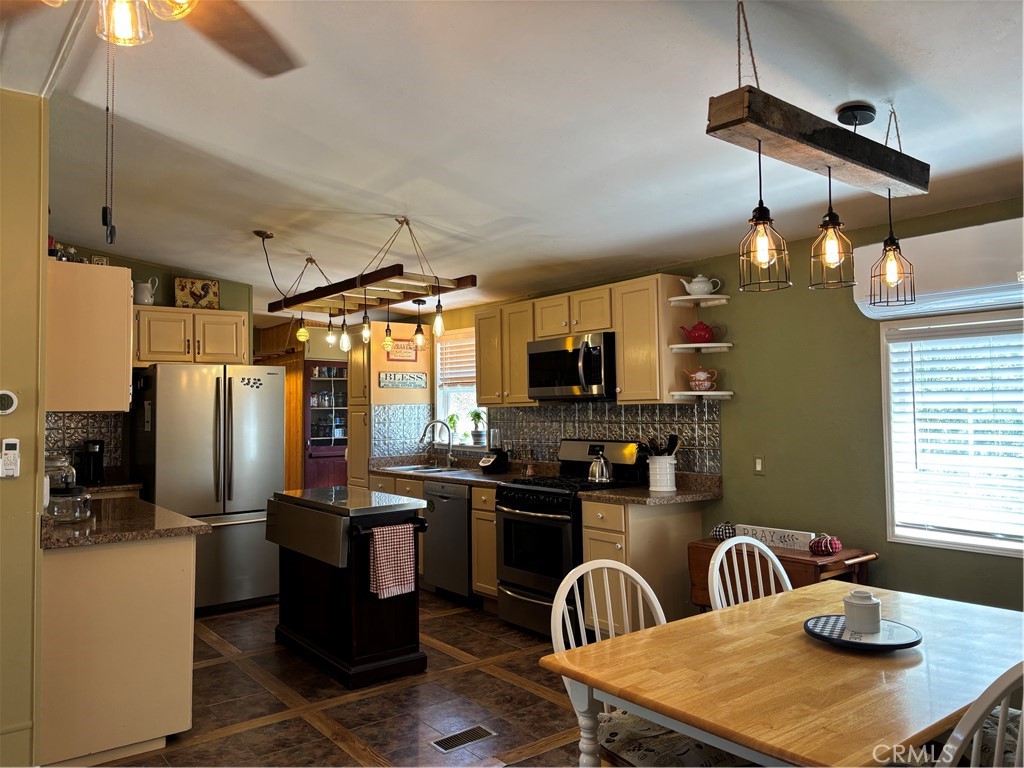 4060 Indian Peak Road Mariposa, CA 95338 - Photo 11 of 60 a kitchen with refrigerator and chairs