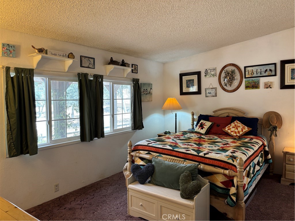 4060 Indian Peak Road Mariposa, CA 95338 - Photo 15 of 60 a bedroom with a bed and a window