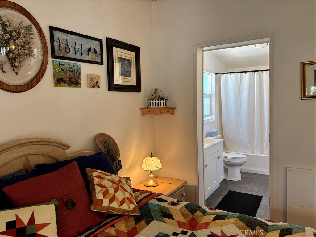 4060 Indian Peak Road Mariposa, CA 95338 - Photo 17 of 60 a bathroom with a toilet and a painting on the wall