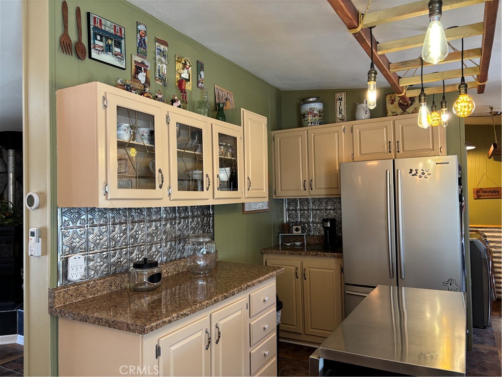4060 Indian Peak Road Mariposa, CA 95338 - Photo 21 of 60 a kitchen with stainless steel appliances granite countertop a sink a refrigerator and wooden cabinets