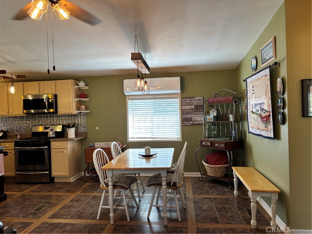 4060 Indian Peak Road Mariposa, CA 95338 - Photo 26 of 60 a dining room with stainless steel appliances kitchen island granite countertop a dining table and chairs