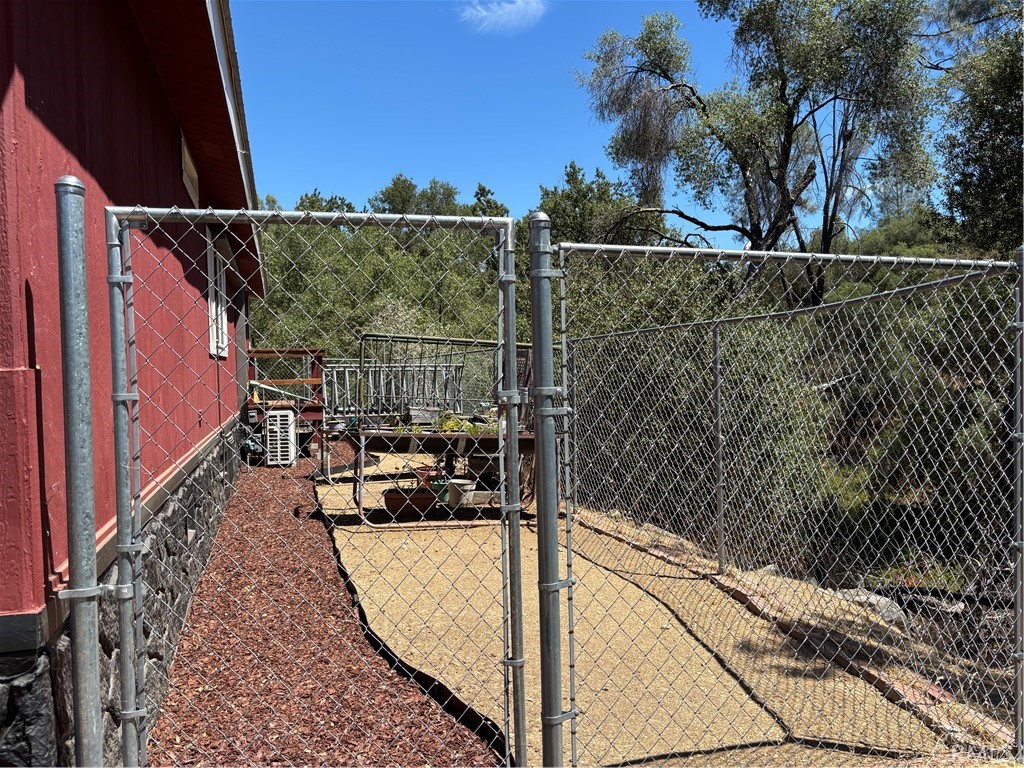 4060 Indian Peak Road Mariposa, CA 95338 - Photo 44 of 60 a view of a brick wall with a tree in the background