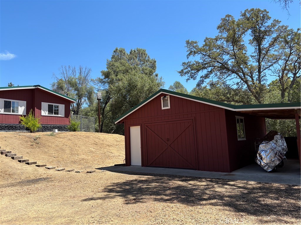 4060 Indian Peak Road Mariposa, CA 95338 - Photo 47 of 60 a house with trees in the background
