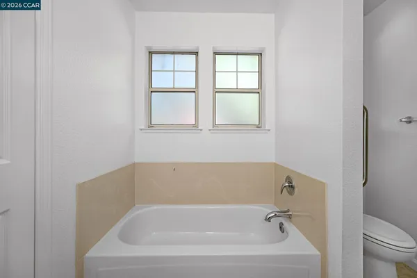 a white bath tub sitting next to a toilet