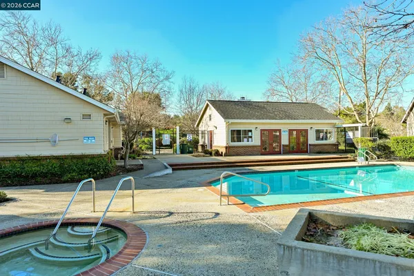 a swimming pool with patio outdoor seating and yard