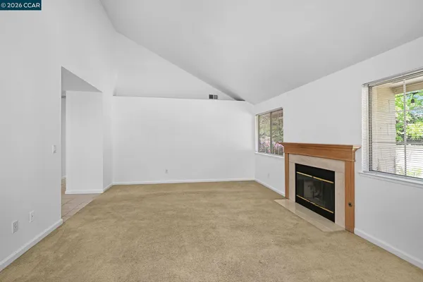 a view of empty room with a fireplace