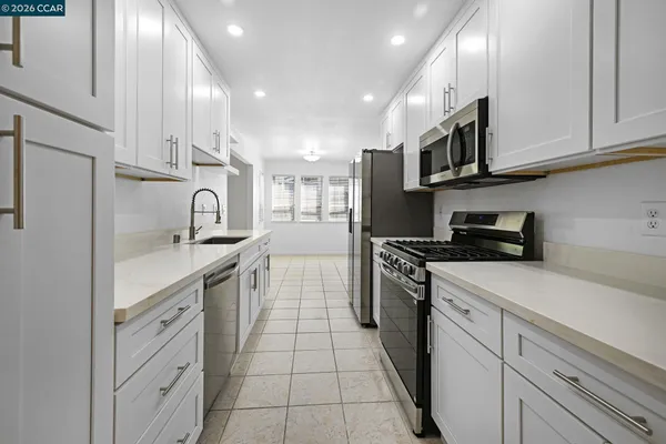a kitchen with cabinets and appliances