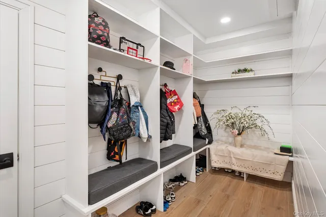 a large kitchen with kitchen island a stove a sink a refrigerator and a dining table with wooden floor