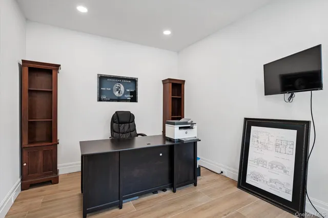 a large kitchen with stainless steel appliances kitchen island granite countertop a lot of counter space and wooden floor