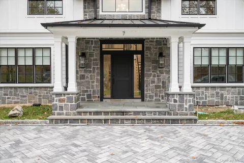 a front view of a house with a lots of windows