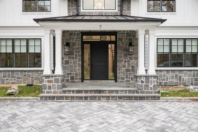 a front view of a house with a lots of windows