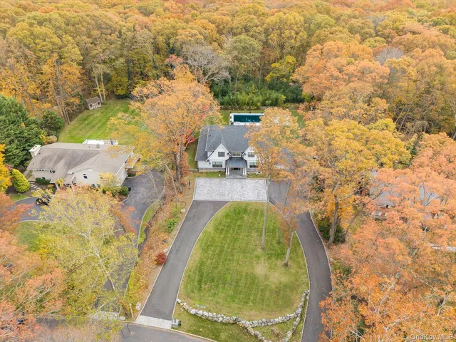 a view of house with yard and swimming pool