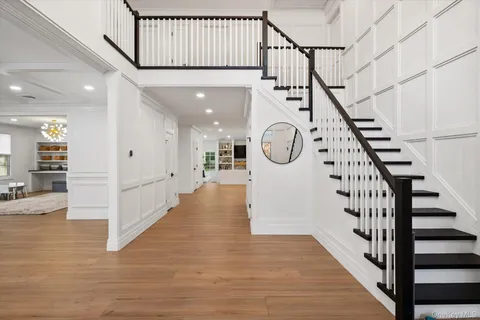 a view of entryway and hall with wooden floor