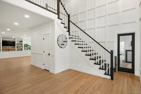 a view of entryway with wooden floor and stairs