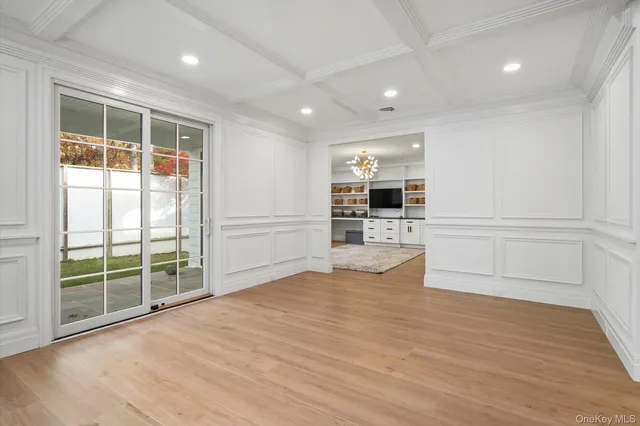 a view of empty room with wooden floor and fireplace