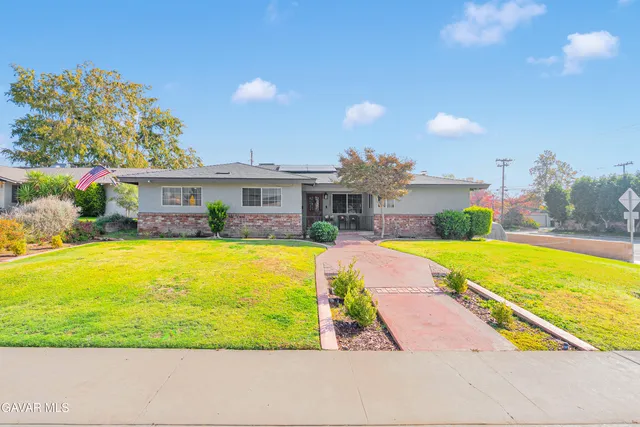 a view of house with swimming pool yard and outdoor seating