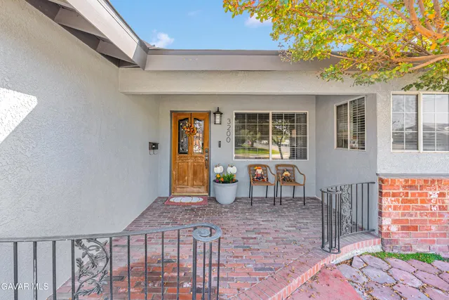 a view of a patio with table and chairs