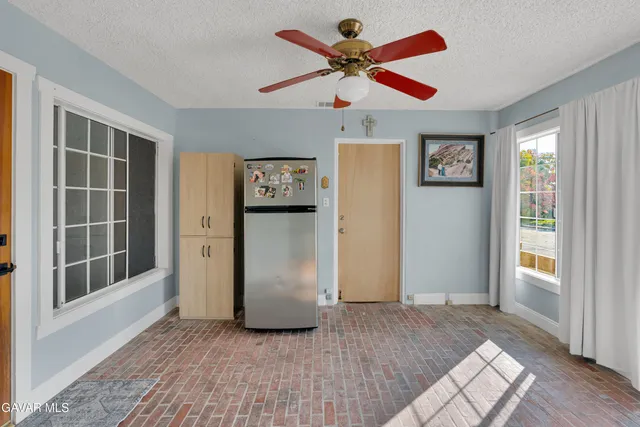 a view of a patio with a table chairs and a backyard