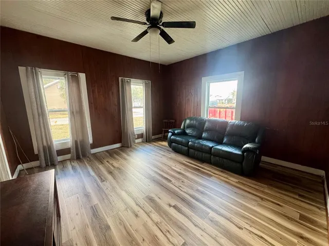 a living room with furniture and a wooden floor