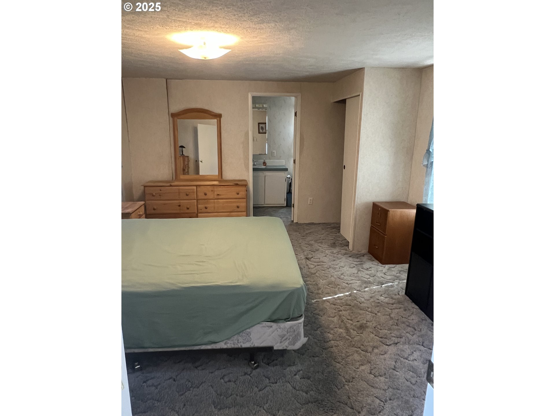 2801 Southwest Hautama Road Pendleton, OR 97801 - Photo 7 of 11 a bedroom with a bed and a mirror