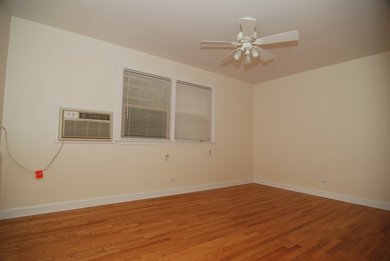 7530 North Ridge Boulevard, Unit 2E Chicago, IL 60645 - Photo 8 of 15 wooden floor in an empty room