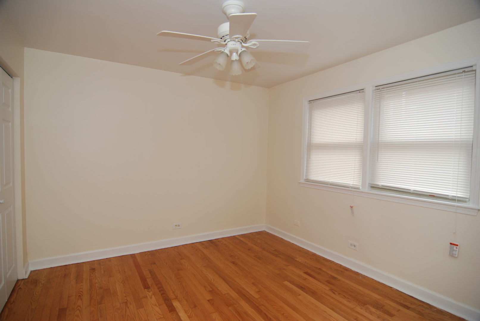 7530 North Ridge Boulevard, Unit 2E Chicago, IL 60645 - Photo 10 of 15 wooden floor in an empty room with a window