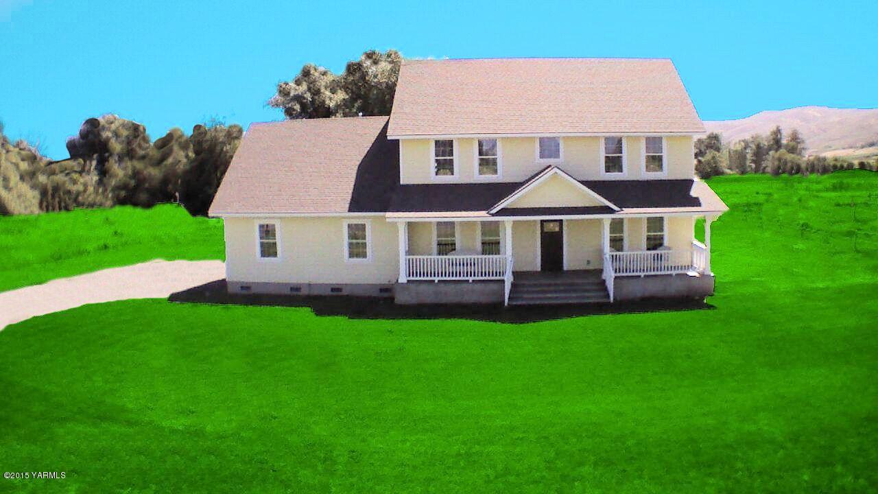 a aerial view of a house with a yard table and chairs