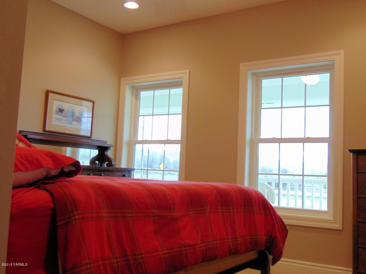 3801 Wiley Road Yakima, WA 98903 - Photo 14 of 20 a bed sitting in a bedroom next to a window
