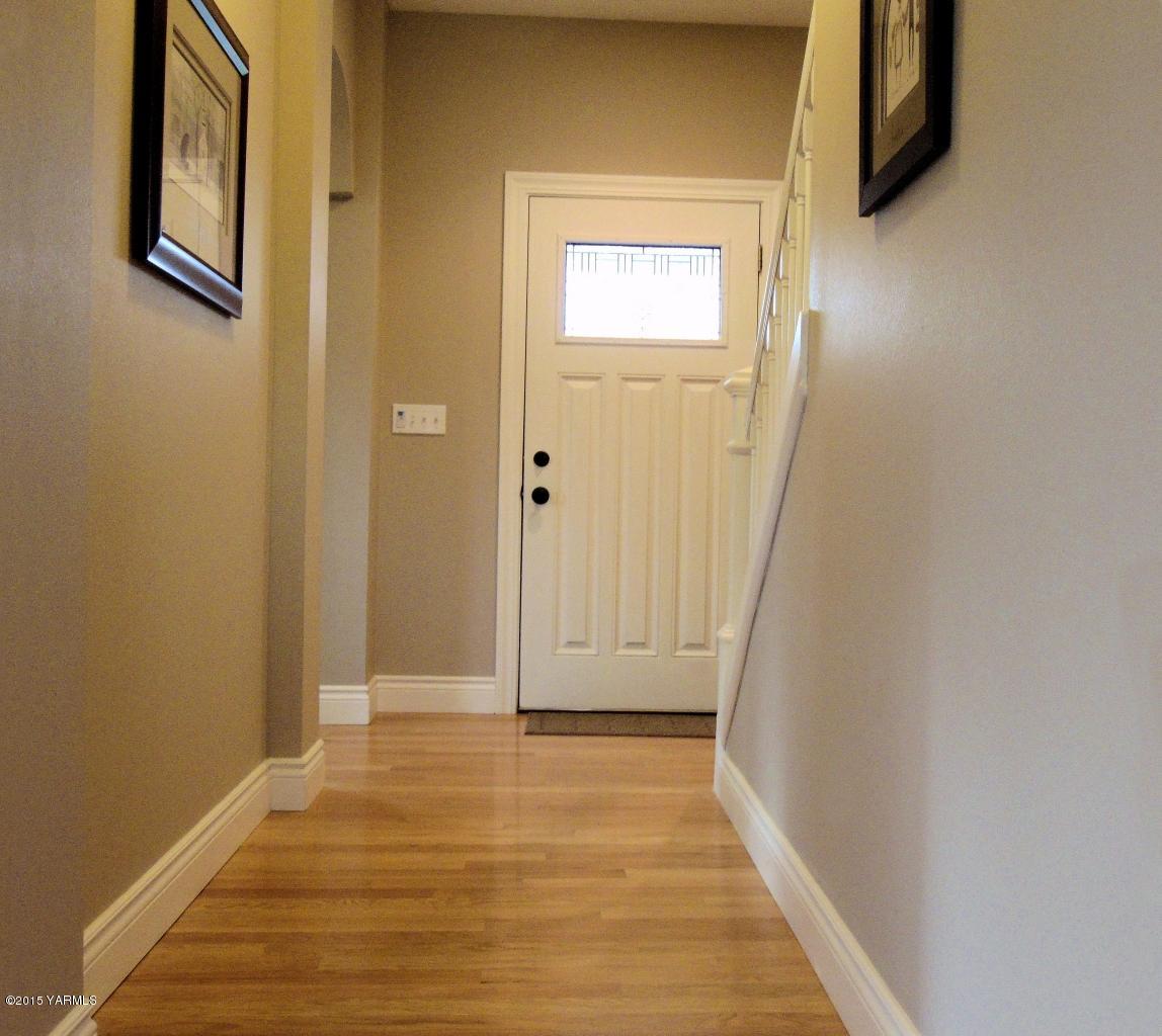 3801 Wiley Road Yakima, WA 98903 - Photo 7 of 20 a view of a hallway with wooden floor and a bathroom