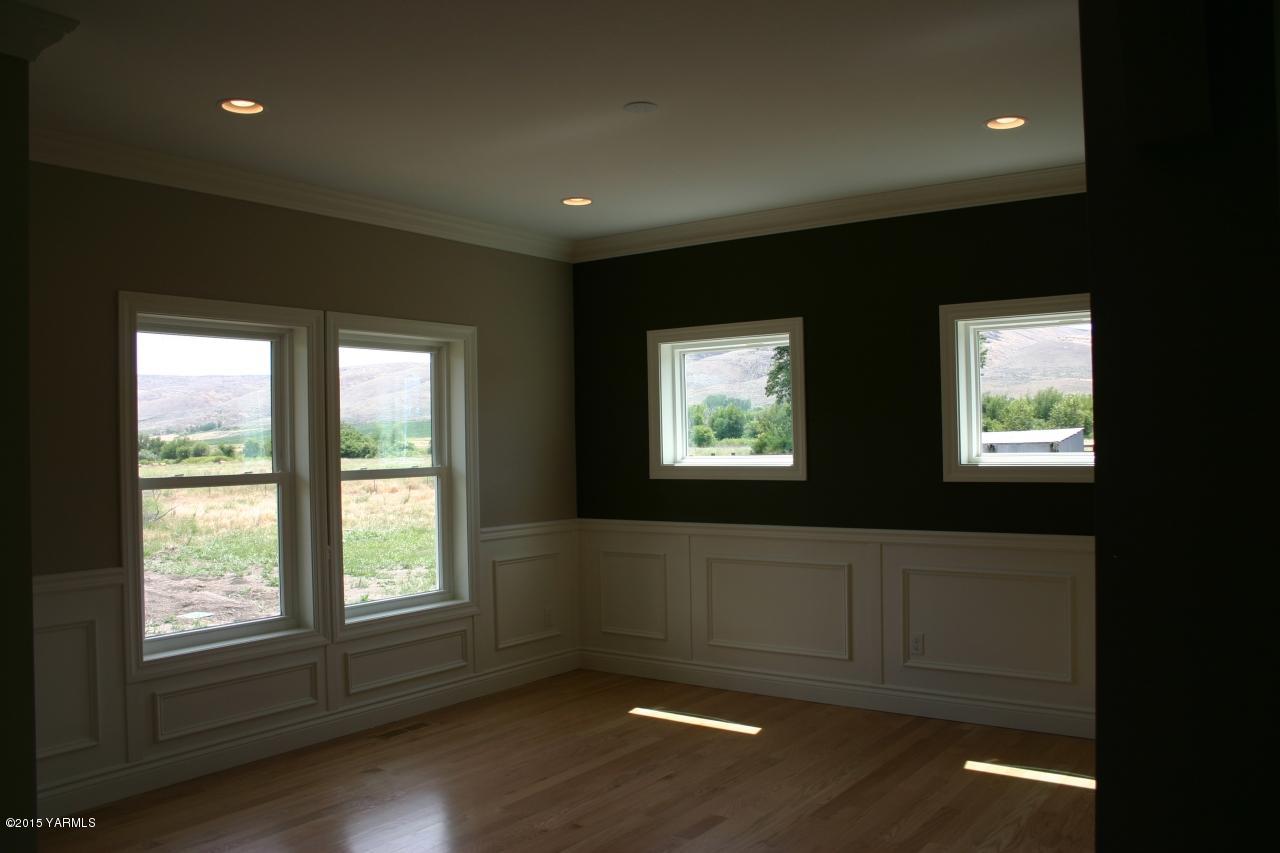 3801 Wiley Road Yakima, WA 98903 - Photo 9 of 20 a view of an empty room with wooden floor and a window