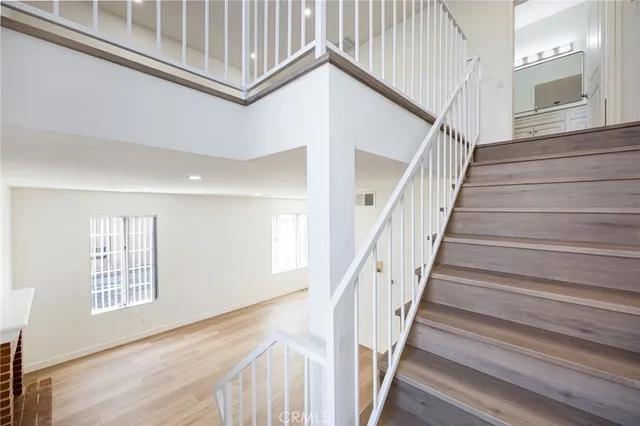 a view of staircase with white walls and a window