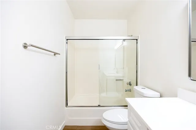 a bathroom with a toilet a sink and a shower