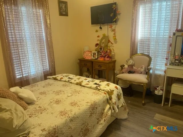 a bedroom with a bed and flat screen tv