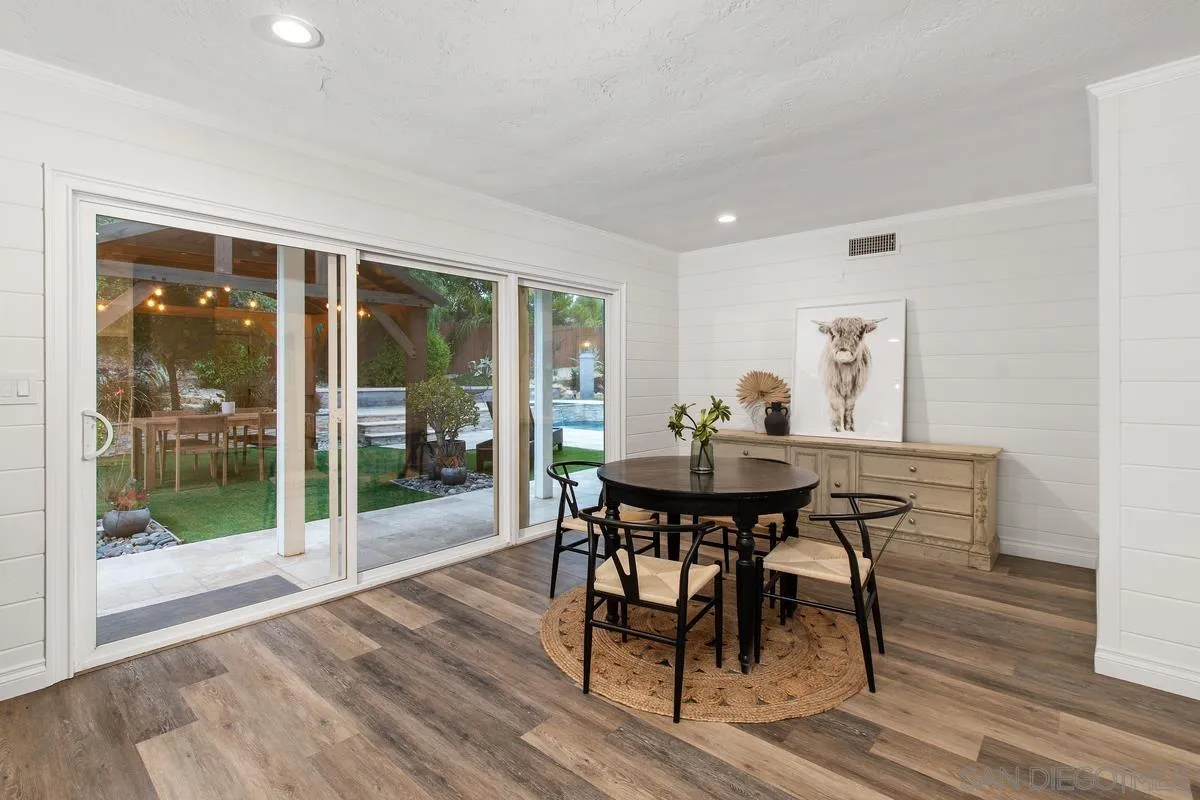 16852 Orchard Bend Road Poway, CA 92064 - Photo 14 of 39 a view of a dining room with furniture and wooden floor