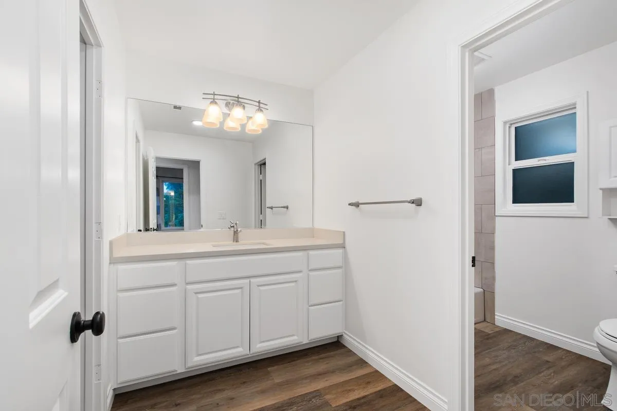 16852 Orchard Bend Road Poway, CA 92064 - Photo 21 of 39 a bathroom with a double vanity sink and a mirror