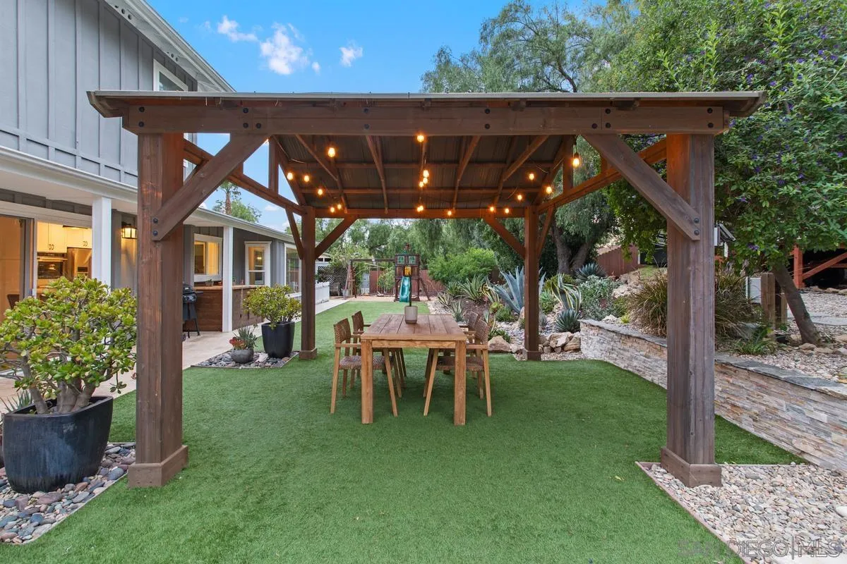 16852 Orchard Bend Road Poway, CA 92064 - Photo 38 of 39 a view of a patio with table and chairs potted plants and floor to ceiling window