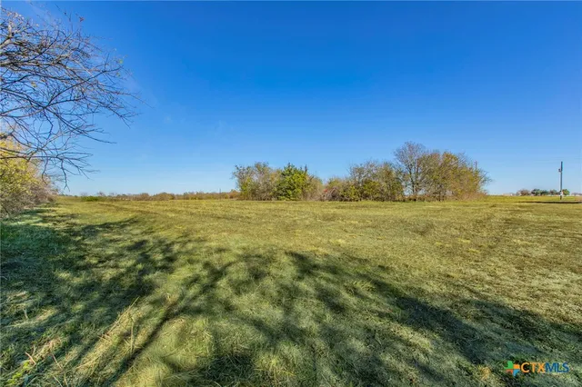 a view of a field with an ocean