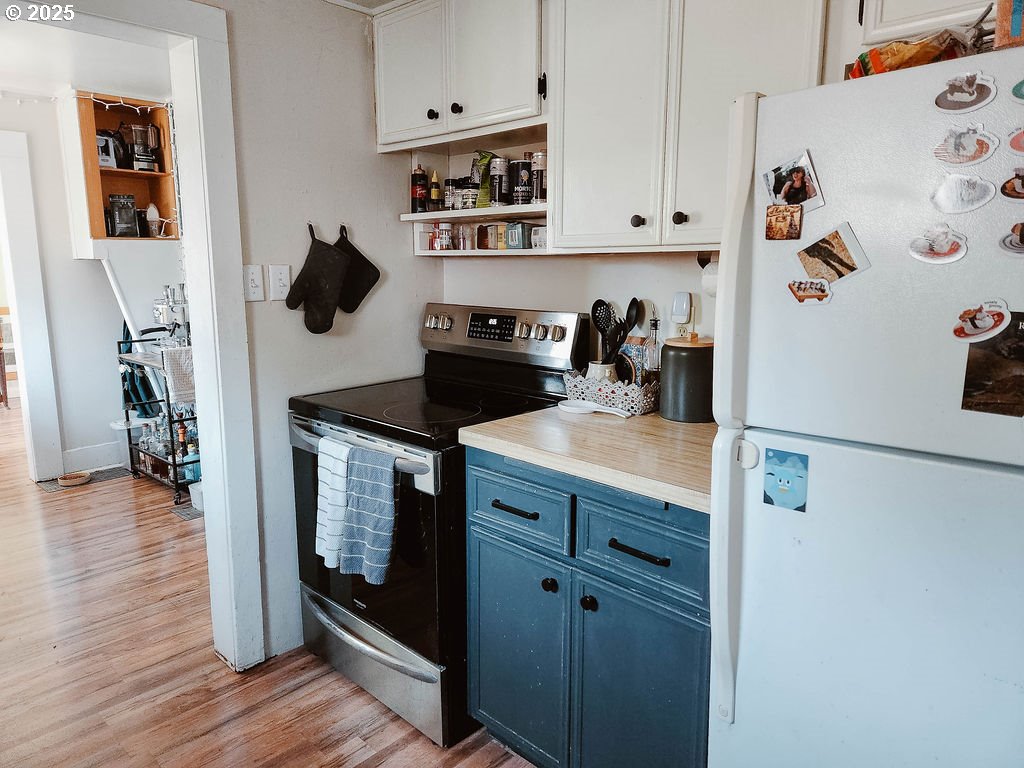 1895 City View Street Eugene, OR 97405 - Photo 11 of 36 a kitchen with a refrigerator and a stove top oven