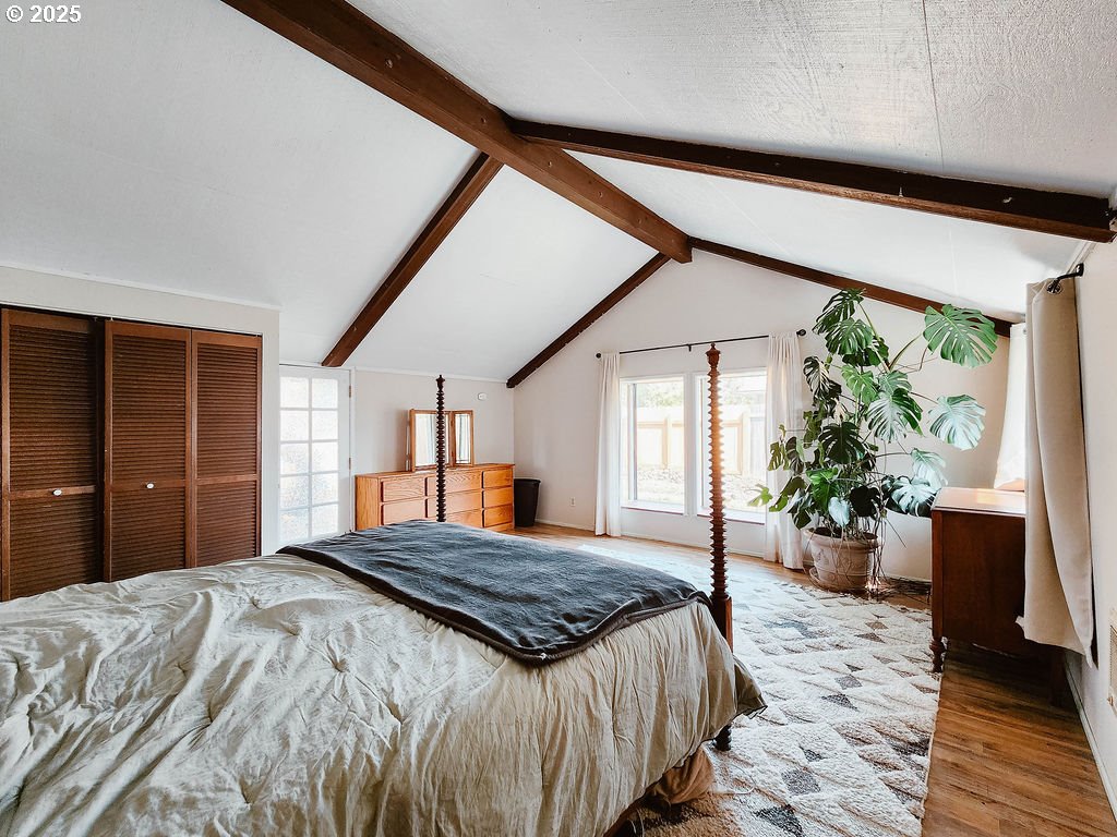1895 City View Street Eugene, OR 97405 - Photo 24 of 36 a bedroom with a large bed and large windows